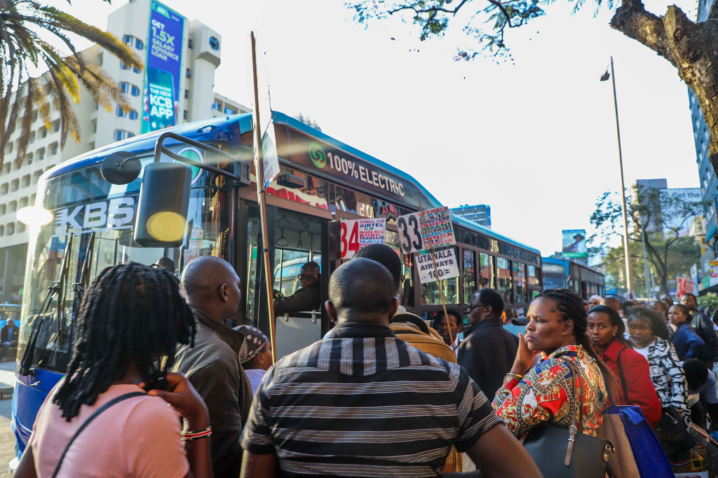 Passengers wait to board an electric Bus In Nairobi Kenya
