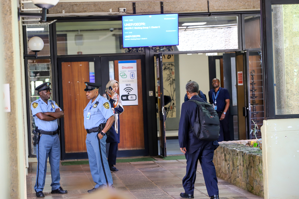 security officers standing talking infront of conference 1 suring UNEA-7