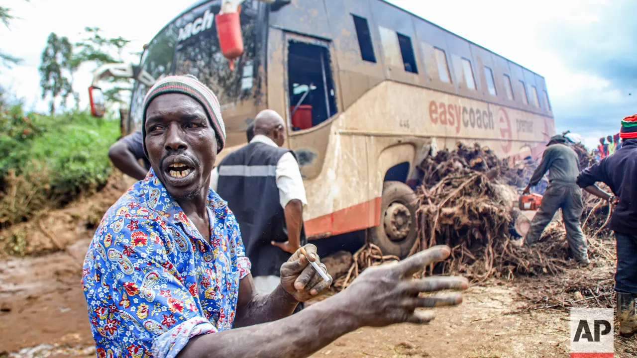 People try to clear a bus that was washed away after a dam burst in Kamuchiri Village Mai Mahiu, Nakuru County, Kenya, Monday, April. 29, 2024. Kenya's Interior Ministry says at least 45 people have died and dozens are missing after a dam collapsed following heavy rains. (AP Photo/Patrick Ngugi) People try to clear a bus that was washed away after a dam burst in Kamuchiri Village Mai Mahiu, Nakuru County, Kenya, Monday, April. 29, 2024. Kenya's Interior Ministry says at least 45 people have died and dozens are missing after a dam collapsed following heavy rains. (AP Photo/Patrick Ngugi)